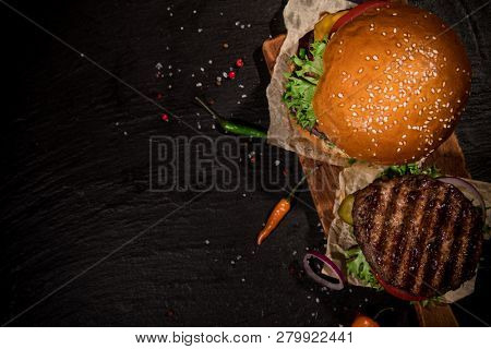 Top view of home made tasty burgers on wooden table.