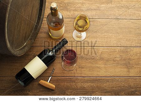 Glass And Bottle Of Red Wine And White Wine With Wooden Barrel Background