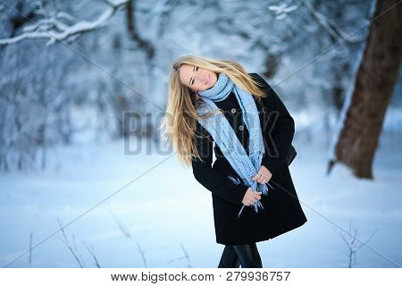 Beautiful Young Girl Smiling And Walking In The Street. Beautiful Snowy Cold Winter. Holiday Mood.