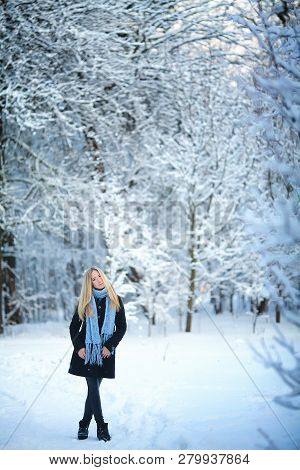 Beautiful Young Girl Smiling And Walking In The Street. Beautiful Snowy Cold Winter. Holiday Mood.