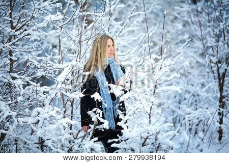 Beautiful Young Girl Smiling And Walking In The Street. Beautiful Snowy Cold Winter. Holiday Mood.