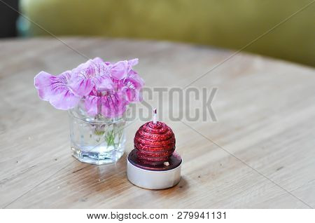 Flower In The Vase And Candle On The Table