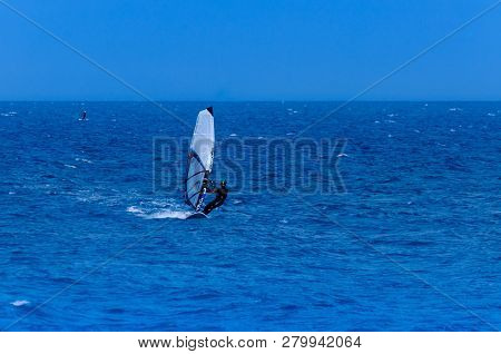 Malaga, Spain - May 25, 2018 Windsurfer Practicing Active Water Sport In The Bay Of Malaga, A Place