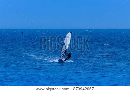 Malaga, Spain - May 25, 2018 Windsurfer Practicing Active Water Sport In The Bay Of Malaga, A Place