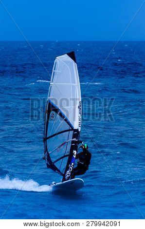 Malaga, Spain - May 25, 2018 Windsurfer Practicing Active Water Sport In The Bay Of Malaga, A Place