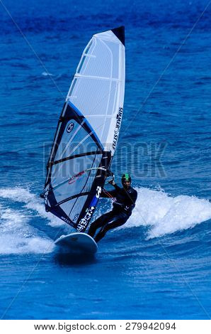 Malaga, Spain - May 25, 2018 Windsurfer Practicing Active Water Sport In The Bay Of Malaga, A Place