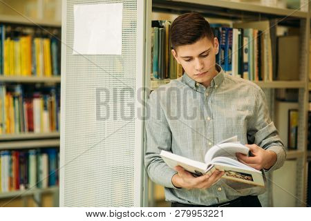 Boy Student In Library Want To Find Some Book. He Read The Book. Heplful Information. Study