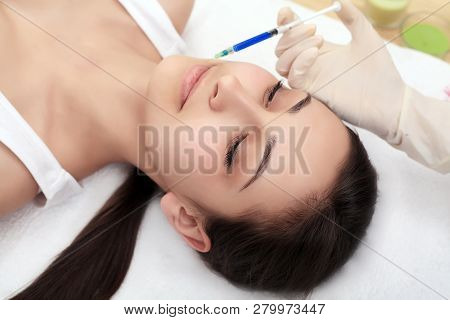 Woman Gets Injection In Her Face. Beauty Woman Giving Injections. Young Woman Gets Beauty Facial Inj