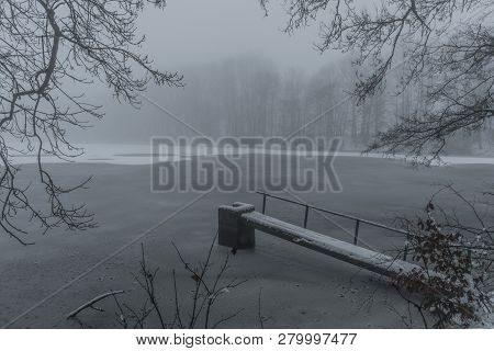 Frosty Pond With Mist And Snow In Dark White Winter Day Near Spa Town Kynzvart