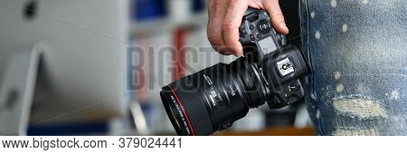 Barcelona, Spain - July 31, 2020: Male Hand Holding Brand New Mirrorless Digital Camera Canon R5 Clo