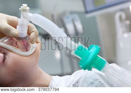 A Little Boy Under Anesthesia. Breathing Mask On The Face. Withdrawal From Anesthesia. Concept Of He