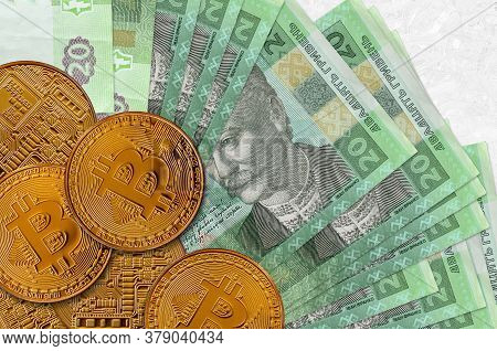 20 Ukrainian Hryvnias Bills And Golden Bitcoins. Cryptocurrency Investment Concept. Crypto Mining Or