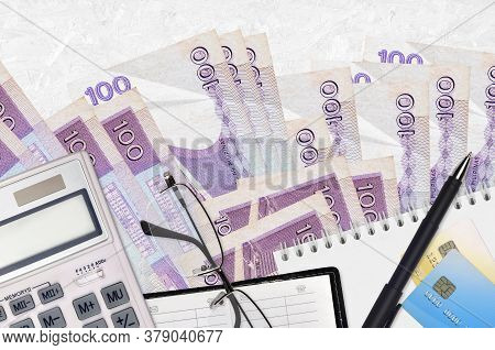 100 Philippine Piso Bills And Calculator With Glasses And Pen. Tax Payment Concept Or Investment Sol