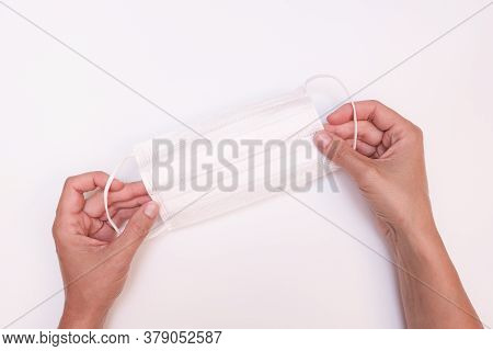 Hands Holding White Protective Surgical Medical Face Mask On White Background, Ppe Personal Protecti