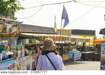 Busan, South Korea - July 20, 2017 : Local Guide With Guided Flag  Leads The Group Of Tourist Walk T