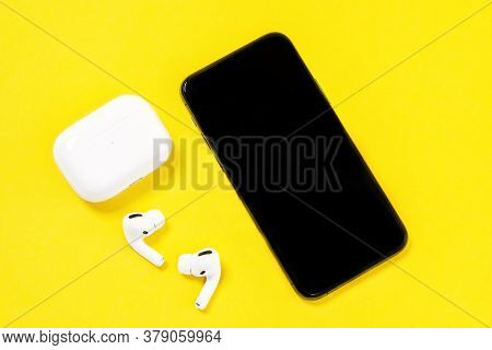 Rostov, Russia - July 06, 2020: Smartphone Apple Iphone 11 Pro And Wireless Headphones With Charging