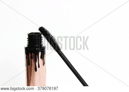 Mascara, Wand Applicator And Black Stroke Against White Background