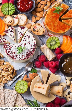 Plate Served With Assortment Of Organic Non-dairy, Raw Cheese From Cashew Nuts With Snacks, Fruits A