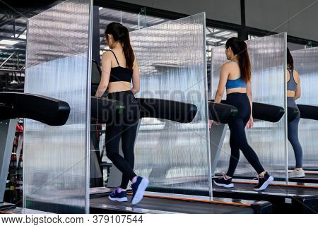 Sporty Woman Workout And Running In Machine Treadmill. Asian Woman Exercise And Lifestyle At Fitness