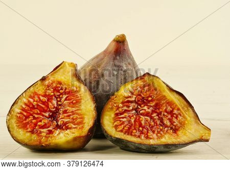 The Figs Are Cut Into Halves, Isolated On White Boards. Close-up. Macrophotography.