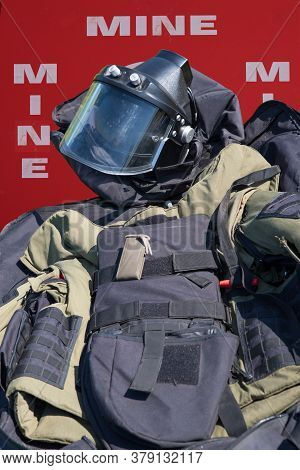 Minefield Warning Sign And Military Protective Costume For Demining. Concept Demining Of Objects.