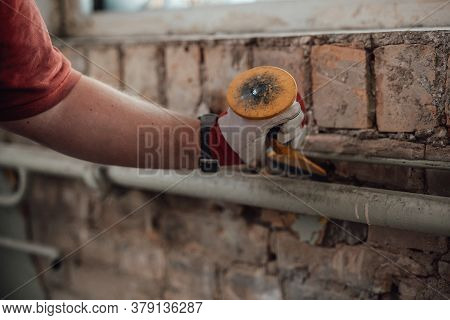 Workers Strong Hands With Hammer And Chisel, Getting Rid Of Plaster On A Brick Wall