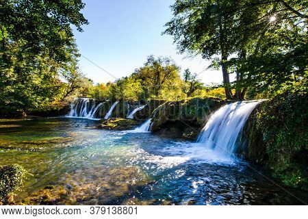 Beautiful sunny day. Scenic waterfall cascades on the river Sluncica. Magnificent Southern Europe, Croatia, small town Slunj. The concept of ecological, active and photo tourism