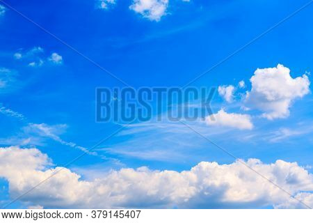 Large White Air Cloud In The Blue Sky. The Weather Forecast Reports On Partly Cloudy Weather And A C
