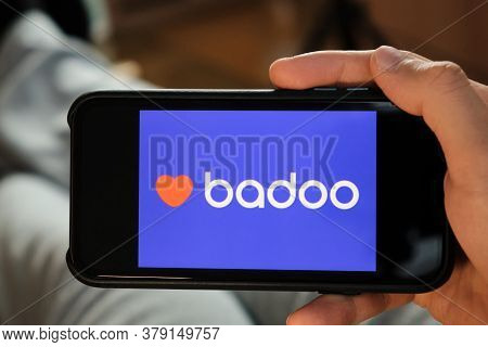 Badoo Application On The Smartphone In Mans Hand. Man Laying And Using Application For Dating And Me