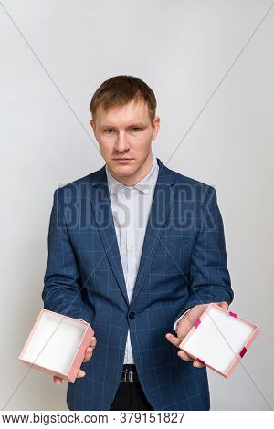 Portrait Of A Young Man With Red Hair In Casual Clothing Jacket And Shirt. Hes Holding An Empty Gift