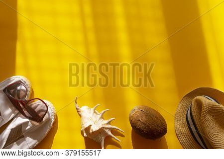 Flat Lay Of Summer And Beach Holiday. Sunglasses, White Espadrilles, Coconut In Yellow Background. C