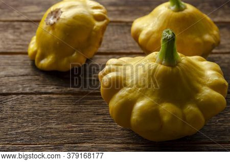 Yellow Pattypan Squash On The Wooden Table