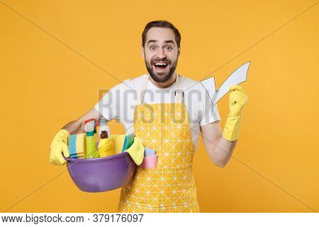 Excited Young Man Househusband In Apron Rubber Gloves Hold Basin Detergent Bottles Washing Cleansers