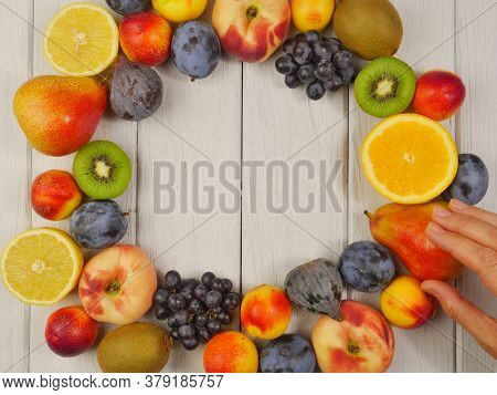 Frame of different exotic fruits on white wooden background, flat lay. Space for text