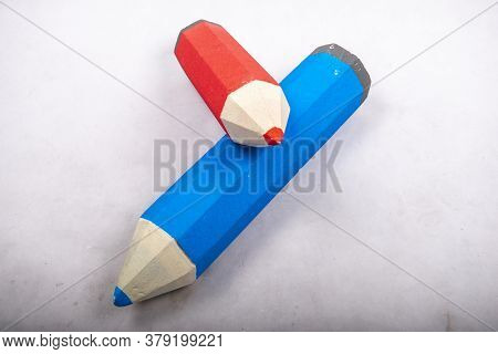 Blue And Red Pencil Stands On A White Background