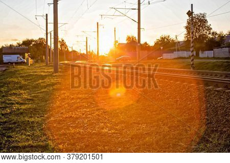 Railway And Railway Crossing On The Background Of A Sunny Sunset, Background. Copy Space For Text