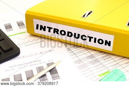 The Yellow Document Folder Is On The Office Desk. Nearby A Calculator And Finance Graphs. Inscriptio