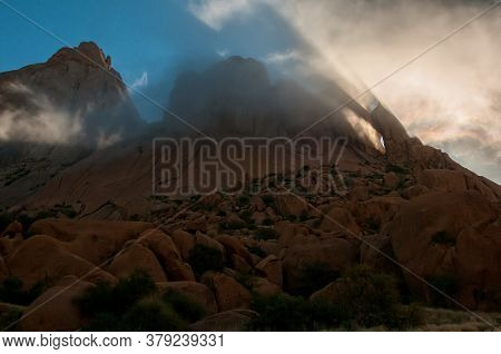 Reflections And Diffraction Are Visible In The Clouds At The Greater Spitzkoppe During Sunrise