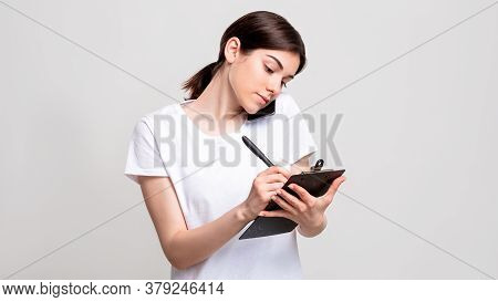 Business Call. Reservation List. Confident Woman With Clipboard Taking Order On Phone Isolated On Wh