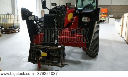 Car -old Forklift, Forklift, Stacker Truck, Warehouse Forklift. Old Car Under Repair In The Garage.
