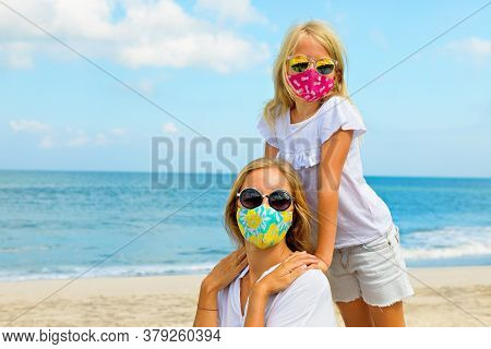 Mother, Child In Stylish Masks Have Fun On Sea Sand Beach. New Rules To Wear Face Covering At Public