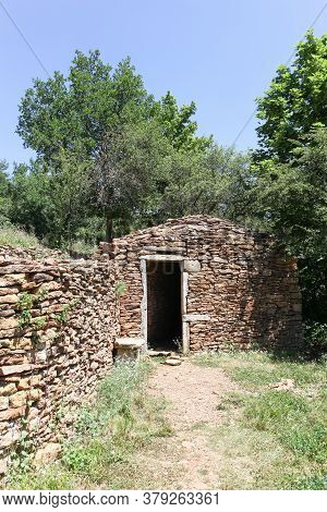 Old And Typical Stone Hut Called Caborne In French Language In Saint Cyr Au Mont Dor, France