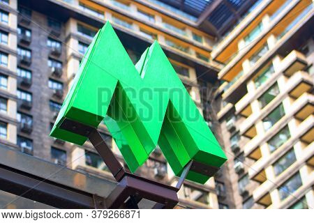 Kyiv, Ukraine - July 04, 2020: Green Metro Sign And Modern Building As Background