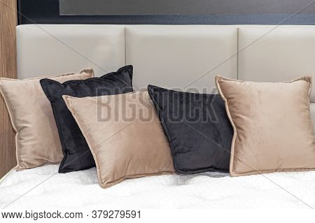 Docorative Plush Pillows And Cushions In Bed