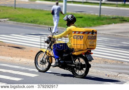 Salvador, Bahia / Brazil - August 10, 2016: Biker From Correios Is Seen Wearing A Helmet While Trave