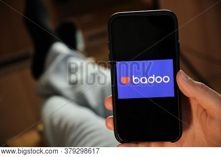 Badoo Application On The Smartphone In Mans Hand. Man Laying And Using Application For Dating And Me