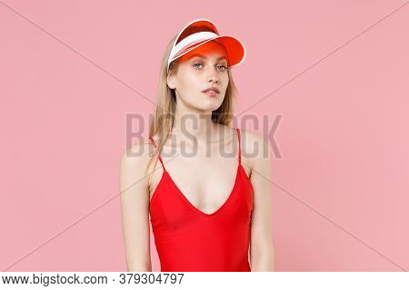 Attractive Young Blonde Woman Girl In Red One-piece Swimsuit Cap Posing Isolated On Pink Background 