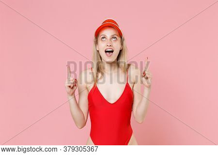 Shocked Young Blonde Woman Girl In Red One-piece Swimsuit Cap Posing Isolated On Pink Background Stu