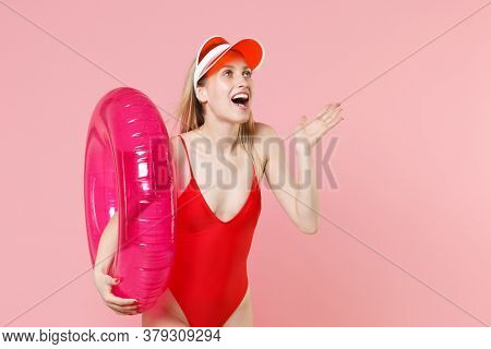 Excited Young Blonde Woman Girl In Red One-piece Swimsuit Cap Isolated On Pink Background. People Su