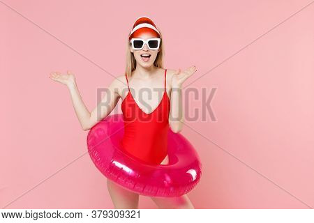 Excited Young Blonde Woman Girl In Red One-piece Swimsuit Cap Glasses With Swim Inflatable Ring Posi